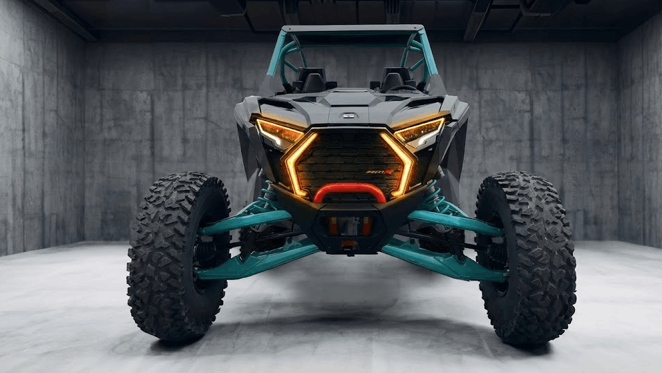 Front view of a Polaris RZR side-by-side with illuminated LED lights, showcasing the complex modern UTV electrical systems that require careful, non-splicing modifications to protect the factory warranty.