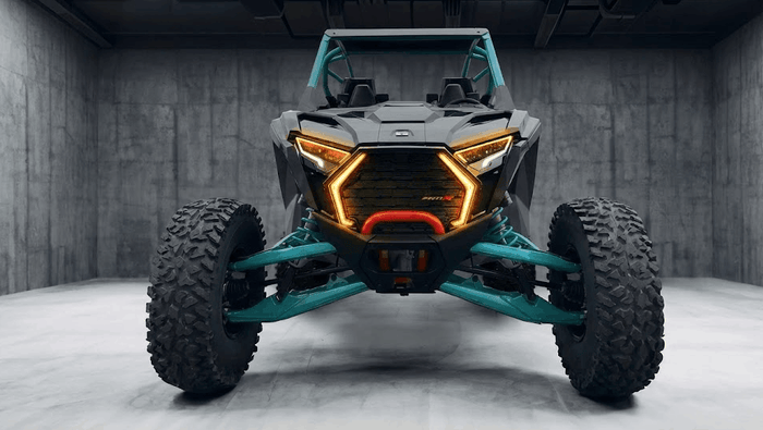 Front view of a Polaris RZR side-by-side with illuminated LED lights, showcasing the complex modern UTV electrical systems that require careful, non-splicing modifications to protect the factory warranty.
