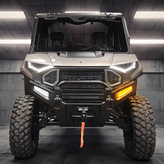 Auxiliary LED pod illuminated as a daytime running light, mounted on a UTV front bumper