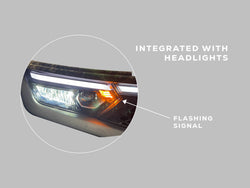 Close-up of the factory headlight unit with integrated turn signal function and wiring connector
