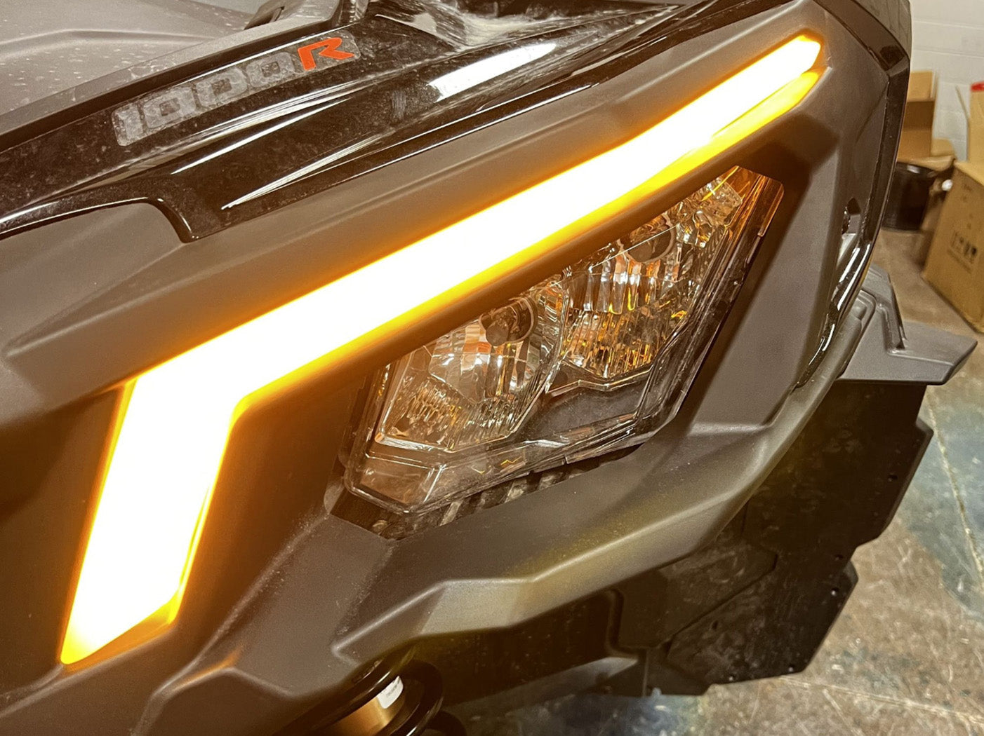 Close-up of signature replacement headlight unit mounted on 2018+ Can Am Maverick X3